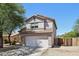 Two-story home with a two-car garage and mature trees at 1356 E 9Th Pl, Casa Grande, AZ 85122