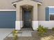 Dark gray front door with sidelights, and a covered entryway at 20279 N 224Th Dr, Surprise, AZ 85387