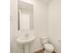 Simple yet elegant powder room, featuring pedestal sink and toilet at 20279 N 224Th Dr, Surprise, AZ 85387