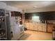 View of kitchen with refrigerator, stove, and cabinets at 1436 W 7Th Pl, Tempe, AZ 85281