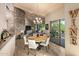 Bright dining area with a stone accent wall and patio access at 41504 N 107Th Way, Scottsdale, AZ 85262