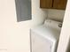 Stackable washer and dryer in a small laundry room with overhead cabinets at 4608 W Maryland Ave # 144, Glendale, AZ 85301