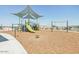 playground with swings, climbing structures, and shade at 24240 W Bowker St, Buckeye, AZ 85326