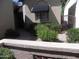 Landscaped front yard with a gated entry and red flowers at 9728 N 106Th Pl # 154, Scottsdale, AZ 85258