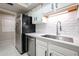 White shaker cabinets, stainless steel sink and dishwasher, and subway tile backsplash at 7761 N 19Th Ln, Phoenix, AZ 85021