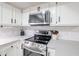 Stainless steel range and microwave complement the white cabinetry and gray countertops at 7761 N 19Th Ln, Phoenix, AZ 85021