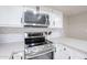 Stainless steel range and microwave complement the white cabinetry and gray countertops at 7761 N 19Th Ln, Phoenix, AZ 85021