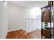 Upstairs hall with wood floors and a modern bookshelf at 7761 N 19Th Ln, Phoenix, AZ 85021