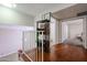 Upstairs hallway showcasing wood floors and access to bedrooms and bathroom at 7761 N 19Th Ln, Phoenix, AZ 85021