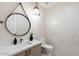 Stylish powder room with a unique tile feature wall at 15864 N 115Th Way, Scottsdale, AZ 85255