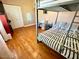 Well-lit bedroom featuring hardwood floors and a bunk bed at 2610 E Nisbet Rd, Phoenix, AZ 85032