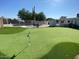 Expansive putting green beside the pool at 2610 E Nisbet Rd, Phoenix, AZ 85032