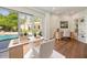 Home office with pool view and built-in shelving at 5302 E Mercer Ln, Scottsdale, AZ 85254