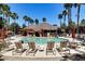 Community pool with plenty of lounge chairs and a shaded area at 14950 W Mountain View Blvd # 1111, Surprise, AZ 85374
