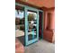 Building entrance with a teal door and a 'No Soliciting' sign at 14950 W Mountain View Blvd # 1111, Surprise, AZ 85374