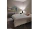 Bedroom with a bed, wall art, and floor lamp at 14950 W Mountain View Blvd # 1111, Surprise, AZ 85374