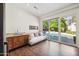 Home office with built-in cabinetry and sliding doors opening to the pool area at 5302 E Mercer Ln, Scottsdale, AZ 85254