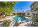 Stunning pool with diving board, surrounded by a beautifully landscaped backyard at 5302 E Mercer Ln, Scottsdale, AZ 85254