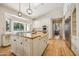 Large kitchen featuring white cabinets, granite island, and stainless steel appliances at 5302 E Mercer Ln, Scottsdale, AZ 85254