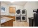 Laundry room with stackable washer and dryer and granite countertop at 5302 E Mercer Ln, Scottsdale, AZ 85254