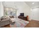 Spacious living room with hardwood floors and a large sectional sofa at 5302 E Mercer Ln, Scottsdale, AZ 85254