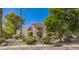 Exterior of a stunning Spanish-style home with lush landscaping and a paved driveway at 5302 E Mercer Ln, Scottsdale, AZ 85254
