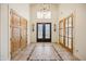 Elegant entryway with double doors, hardwood floors, and a beautiful chandelier at 5302 E Mercer Ln, Scottsdale, AZ 85254