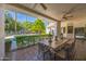 Outdoor patio with seating area, offering a view of the pool and lush landscaping at 5302 E Mercer Ln, Scottsdale, AZ 85254