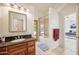 Bathroom with granite vanity, bathtub, and access to backyard at 5302 E Mercer Ln, Scottsdale, AZ 85254