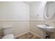 Small half bathroom with pedestal sink and wainscoting at 845 W Edgemont Ave, Phoenix, AZ 85007