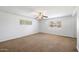 Well-lit bedroom with neutral carpeting and a ceiling fan at 845 W Edgemont Ave, Phoenix, AZ 85007