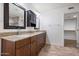 Double vanity bathroom with granite countertops and dark wood cabinets at 845 W Edgemont Ave, Phoenix, AZ 85007