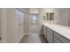 Bathroom with double vanity, shower, and view into bedroom at 2869 N Coronado Dr, Florence, AZ 85132