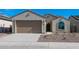 Single-story home with a two-car garage and desert landscaping at 2869 N Coronado Dr, Florence, AZ 85132