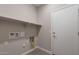 Laundry room with built-in shelving and hookups at 2869 N Coronado Dr, Florence, AZ 85132