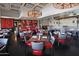 Restaurant dining area with red and gray chairs, and a wood-fired oven at 9833 E Gemini Pl, Sun Lakes, AZ 85248