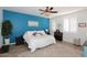 Bedroom with a teal accent wall, plush bedding and wood-look floors at 17025 E La Montana Dr # 107, Fountain Hills, AZ 85268