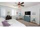 Bright bedroom with a queen bed, dresser, and large windows at 17025 E La Montana Dr # 107, Fountain Hills, AZ 85268
