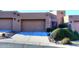 Tan stucco exterior with two-car garage and nicely landscaped front yard at 17025 E La Montana Dr # 107, Fountain Hills, AZ 85268
