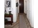 Bright hallway with wood-look floors and a decorative console table at 17025 E La Montana Dr # 107, Fountain Hills, AZ 85268