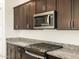 Stainless steel appliances and dark wood cabinets in this kitchen at 4651 N 177Th Ln, Goodyear, AZ 85395