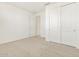 Simple bedroom with neutral carpet and double door closet at 4657 N 177Th Ln, Goodyear, AZ 85395