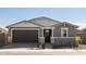 Single-story home with gray exterior, brown garage door, and stone accents at 4657 N 177Th Ln, Goodyear, AZ 85395