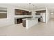 Open concept kitchen with island, dark cabinets, and granite countertops at 4657 N 177Th Ln, Goodyear, AZ 85395