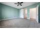 Bedroom with barn door, carpet, and access to bathroom at 41333 N Belfair Way, Anthem, AZ 85086