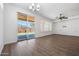 Living room with sliding door to patio and hardwood floors at 41333 N Belfair Way, Anthem, AZ 85086