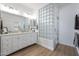 Bathroom with double vanity, glass block shower, and wood flooring at 41333 N Belfair Way, Anthem, AZ 85086