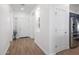 View of entryway and kitchen with wood-look floors and white doors at 41333 N Belfair Way, Anthem, AZ 85086