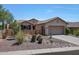 Single story home with landscaped front yard and garage at 41333 N Belfair Way, Anthem, AZ 85086