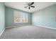 Light teal bedroom with ceiling fan and carpeted floor at 41333 N Belfair Way, Anthem, AZ 85086